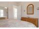 Guest bedroom with twin beds, wicker dresser and adjacent bathroom at 5814 Benevento Dr, Sarasota, FL 34238