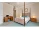 Bedroom with four-poster bed, built-in desk and mirrored closet at 5814 Benevento Dr, Sarasota, FL 34238