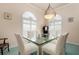 Formal dining room with a glass-top table and seating for six at 5814 Benevento Dr, Sarasota, FL 34238