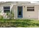 House exterior featuring a blue front door and well-manicured lawn at 2345 Floyd St, Sarasota, FL 34239