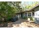 Home's side exterior showcasing a covered patio area at 600 Dream Island Rd, Longboat Key, FL 34228