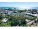 Aerial view showing a waterfront community with lush landscaping and a beautiful beach at 600 Dream Island Rd, Longboat Key, FL 34228