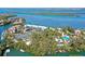 Aerial view showcasing waterfront lot, tennis courts, and nearby buildings at 600 Dream Island Rd, Longboat Key, FL 34228