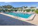 Community pool with plenty of lounge chairs for relaxation at 3915 Schwalbe Dr # 128, Sarasota, FL 34235