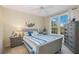 Comfortable bedroom with a gray sleigh bed, dresser, and large window at 4166 Central Sarasota Pkwy # 533, Sarasota, FL 34238