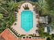 Resort-style pool with surrounding lounge chairs and lush tropical landscaping at 4166 Central Sarasota Pkwy # 533, Sarasota, FL 34238