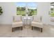 Cozy sitting area with two chairs and a table, overlooking a beautiful view at 3884 Santa Caterina Blvd, Lakewood Ranch, FL 34211