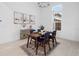 Modern dining room with a wooden table and four blue chairs at 3884 Santa Caterina Blvd, Lakewood Ranch, FL 34211