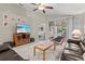 A cozy living room features neutral tones, stylish decor, and sliding glass doors to the patio at 4211 Fairway Pl, North Port, FL 34287