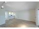 Living room with laminate wood flooring and access to kitchen at 4576 Ringwood Mdw # 5, Sarasota, FL 34235