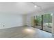 Spacious living room with sliding glass doors and wood-look flooring at 4576 Ringwood Mdw # 5, Sarasota, FL 34235