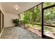 Relaxing screened patio with tile flooring and lush landscaping at 4576 Ringwood Mdw # 5, Sarasota, FL 34235
