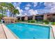 Community pool with lounge chairs and patio area at 4576 Ringwood Mdw # 5, Sarasota, FL 34235