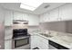Updated kitchen featuring granite countertops and white cabinets at 4576 Ringwood Mdw # 5, Sarasota, FL 34235