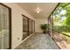 Covered patio with sliding glass doors and garden view at 4576 Ringwood Mdw # 5, Sarasota, FL 34235