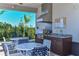 Outdoor kitchen with grills and seating area at 27460 Janzen Ct, Englewood, FL 34223