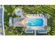 Aerial view of community pool, hot tub, and surrounding landscaping at 27460 Janzen Ct, Englewood, FL 34223