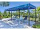 Striped cabana with comfortable lounge chairs at 27460 Janzen Ct, Englewood, FL 34223