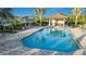 Inviting community pool with a cabana and shaded seating at 27460 Janzen Ct, Englewood, FL 34223
