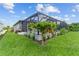 Landscaped backyard with a screened pool and cabana at 196 Arch Dr, Rotonda West, FL 33947