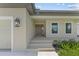 Front entrance with steps leading to a covered porch at 196 Arch Dr, Rotonda West, FL 33947