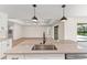 Kitchen island with granite countertop and sink, open to living area at 196 Arch Dr, Rotonda West, FL 33947