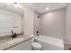 Bathroom with a bathtub, vanity, and neutral tile at 196 Arch Dr, Rotonda West, FL 33947