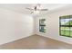 Spacious bedroom with ceiling fan and large windows at 196 Arch Dr, Rotonda West, FL 33947