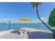 Waterfront patio seating with yellow umbrella at 771 John Ringling Blvd # 22Fair, Sarasota, FL 34236