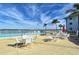 Refreshing community pool with lounge chairs and umbrellas at 771 John Ringling Blvd # 22Fair, Sarasota, FL 34236