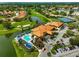 Aerial view of community clubhouse, pool, golf course, and tennis courts at 4115 Putter Pl # 4115, Bradenton, FL 34203