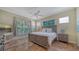 Spacious bedroom with large windows, tile flooring, and a comfortable bed at 5050 Hanging Moss Ln, Sarasota, FL 34238