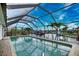 Screened-in pool area with beautiful water views and a view of the community canal at 1236 Swan Ct, Punta Gorda, FL 33950