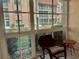 Relaxing lanai with wicker furniture and view of the community at 1310 Glen Oaks E Dr # 182E, Sarasota, FL 34232