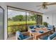 Screened patio with outdoor dining set and golf course view at 5188 Marsh Field Ln # 93, Sarasota, FL 34235