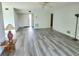 Spacious living room featuring wood-look floors and ample natural light at 5188 Marsh Field Ln # 93, Sarasota, FL 34235