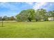 Landscaped backyard with mature trees at 5188 Marsh Field Ln # 93, Sarasota, FL 34235