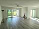 Spacious living room with wood-look floors and sliding glass doors at 5188 Marsh Field Ln # 93, Sarasota, FL 34235