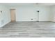 Living room with wood-look floors and access to a patio at 5188 Marsh Field Ln # 93, Sarasota, FL 34235