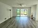 Spacious living room with wood-look floors and sliding glass doors at 5188 Marsh Field Ln # 93, Sarasota, FL 34235
