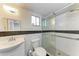 Updated bathroom with a glass-enclosed shower, modern fixtures, and contrasting black and white tile accents at 3514 Lake Bayshore Dr # K-108, Bradenton, FL 34205