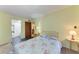 Cozy bedroom with floral bedding and an en-suite bathroom featuring a seamless transition for easy access at 3514 Lake Bayshore Dr # K-108, Bradenton, FL 34205