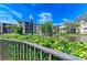 Exterior view of condo building with pond and fountain. Lush landscaping and mature trees at 625 30Th W Ave # G403, Bradenton, FL 34205