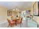 Dining area with glass-top table, wicker chairs, and a chandelier at 625 30Th W Ave # G403, Bradenton, FL 34205