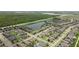 Aerial view of a residential neighborhood with houses, roads, and a lake at 18901 Muhly Grass Ln, Lutz, FL 33558