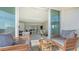 Balcony has sliding glass doors and seating area with a view into the living room at 1771 Ringling Blvd # 604, Sarasota, FL 34236