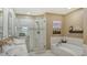 Bathroom with a double vanity, a walk-in shower, and a soaking tub at 1771 Ringling Blvd # 604, Sarasota, FL 34236