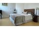 Serene bedroom with stylish headboard, neutral bedding, and hardwood floors at 1771 Ringling Blvd # 604, Sarasota, FL 34236