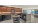 Modern kitchen with black cabinets, stainless steel appliances, wine rack, and open to the living room at 1771 Ringling Blvd # 604, Sarasota, FL 34236