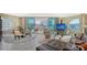Bright living room features a leather couch, round table and large windows with views of the city at 1771 Ringling Blvd # 604, Sarasota, FL 34236